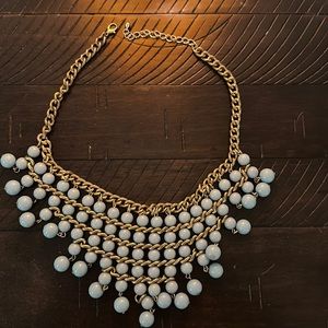 The beads are blue, and the chain is gold